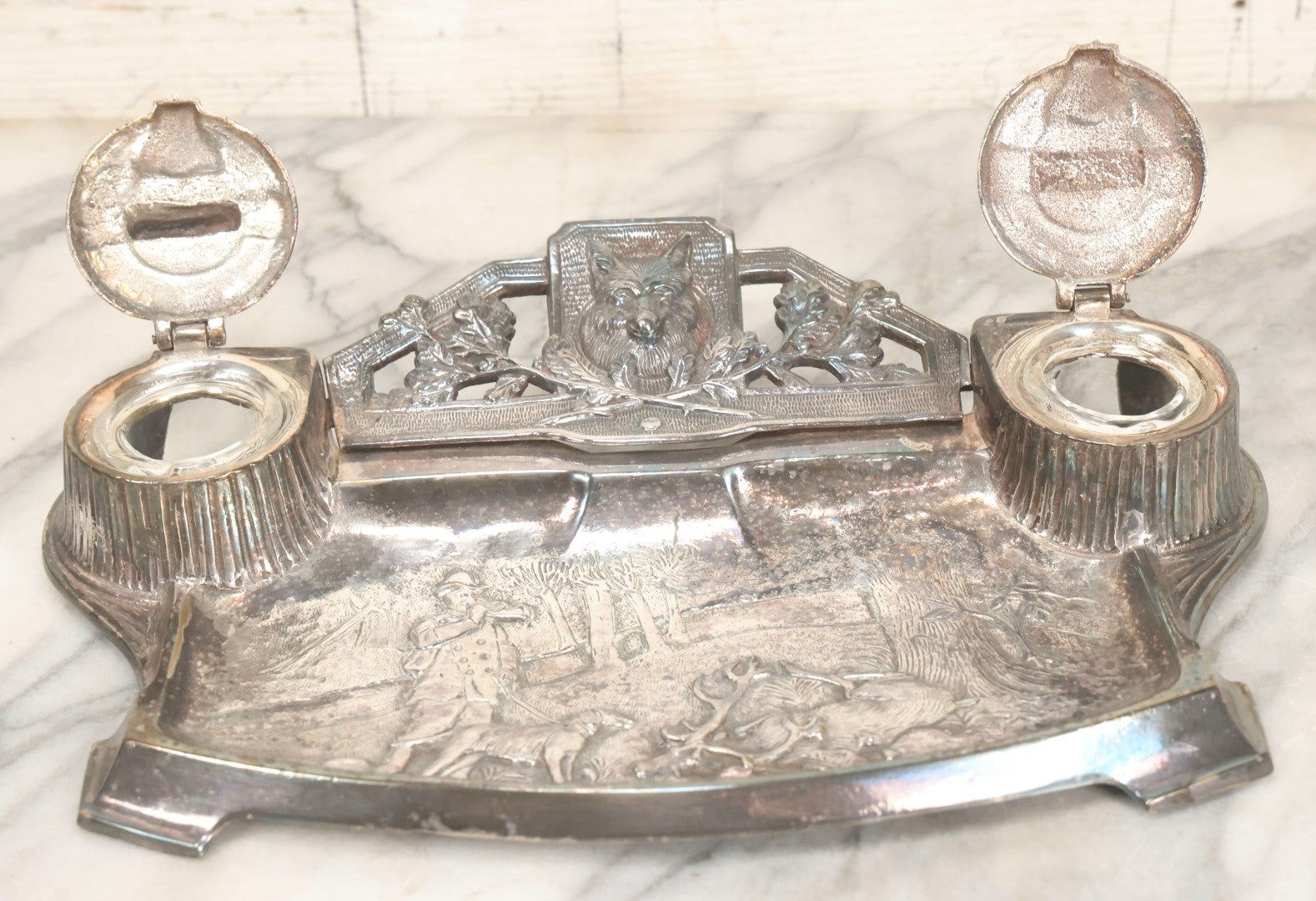 Lot 052 - Antique Cast Iron Double Inkwell With Chrome Finish Depicting Fox Head, Oak Branches, And English Hunting Scene With Hunter, Dog, And Stag, Stamped L.P., Circa Early 20th Century