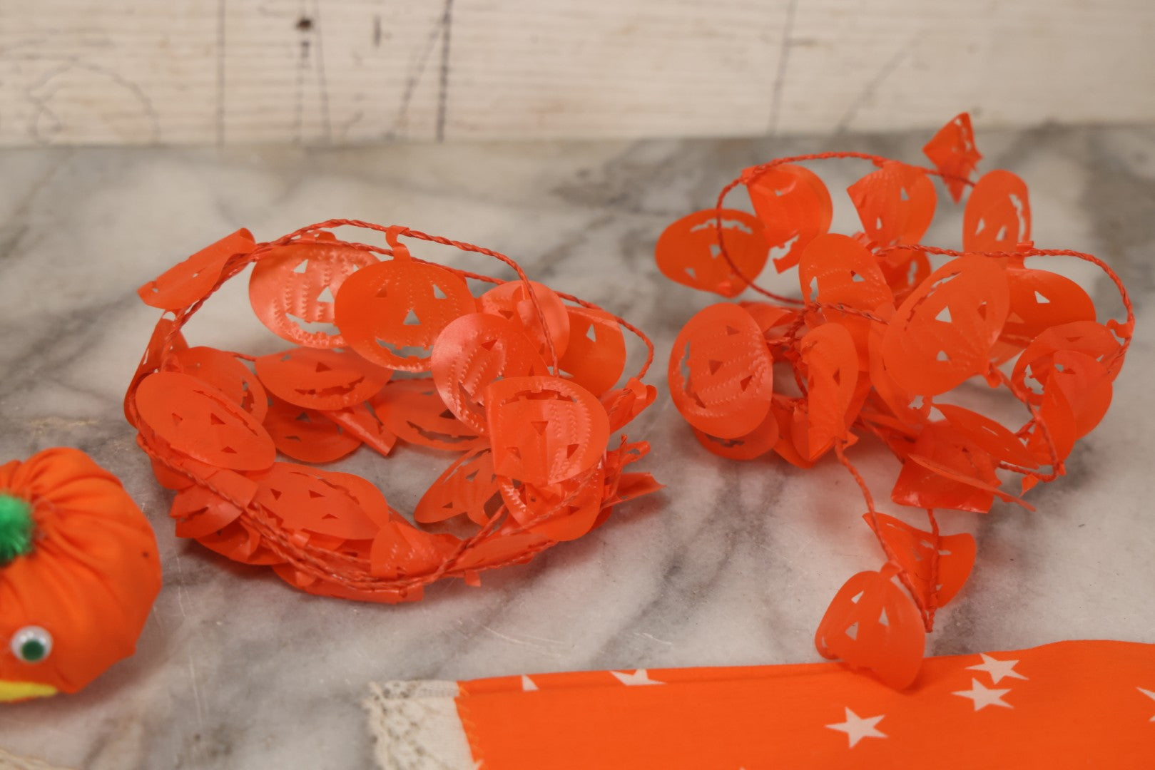 Lot 090 - Grouping Of Hallowe'en Toys And Crafts, Including Rubber Bat, Stuffed Knit Pumpkin, Three Painted Spider Placemats, Four Jack-O-Lantern Cellophane Garlands, And Google-Eyed Jack-O-Lantern Pin Cushion