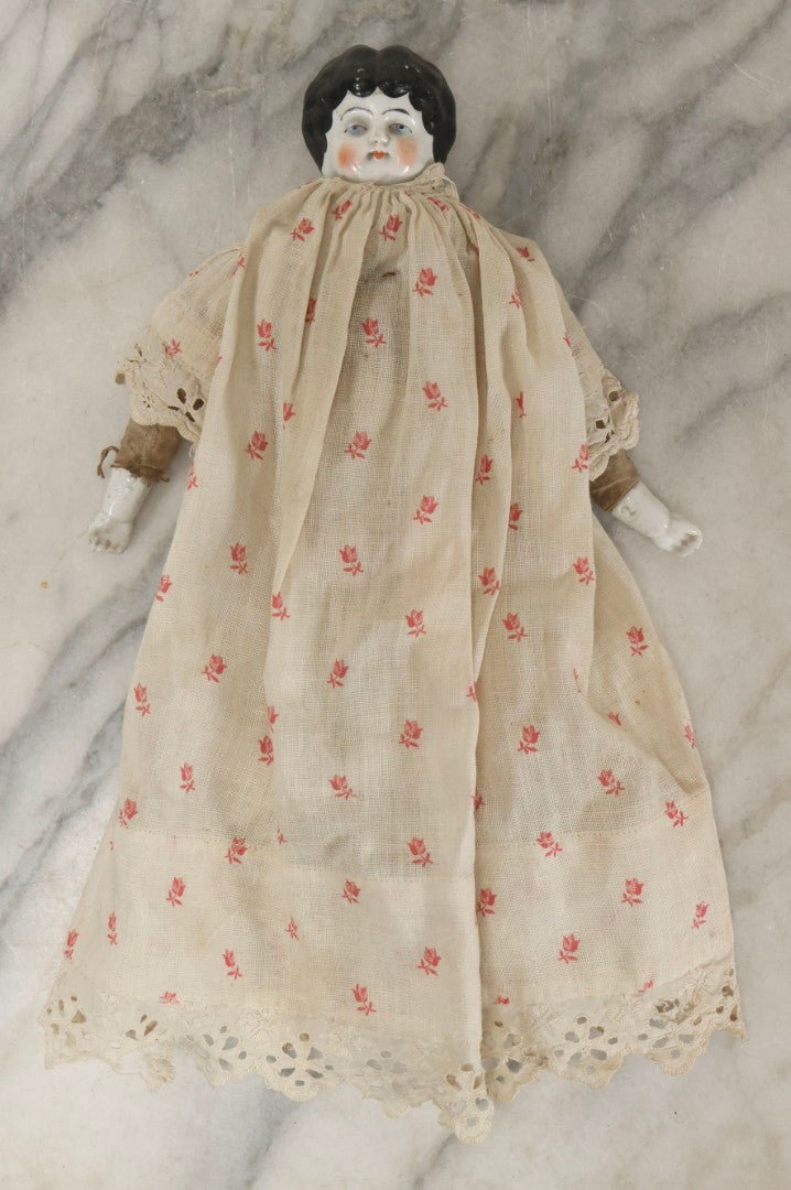 Lot 093 - Antique Doll With Porcelain Head, Hands And Feet And Cloth Body, With White Nightgown With Red Flower Print And Lace Borders, 12-1/4" H