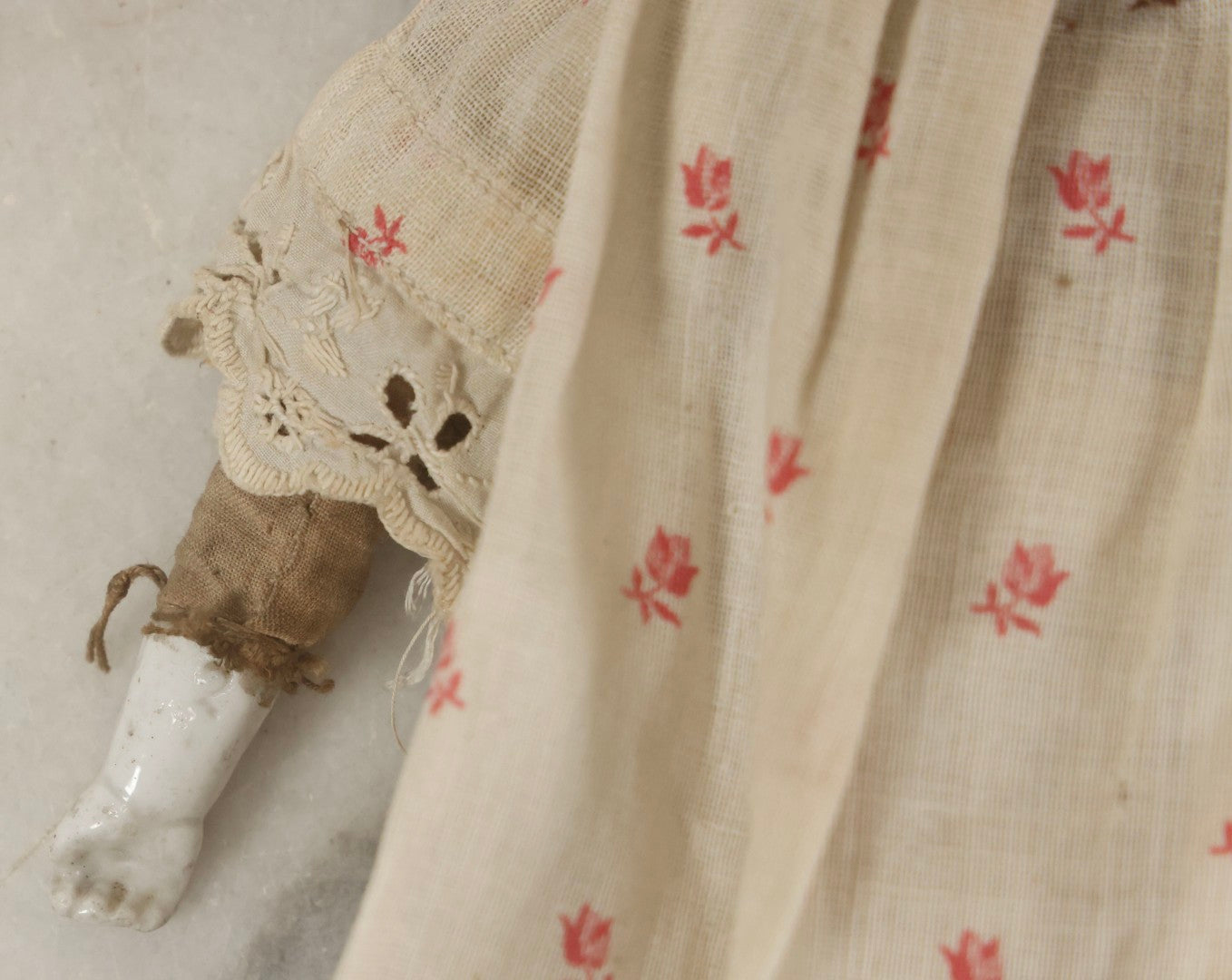Lot 093 - Antique Doll With Porcelain Head, Hands And Feet And Cloth Body, With White Nightgown With Red Flower Print And Lace Borders, 12-1/4" H