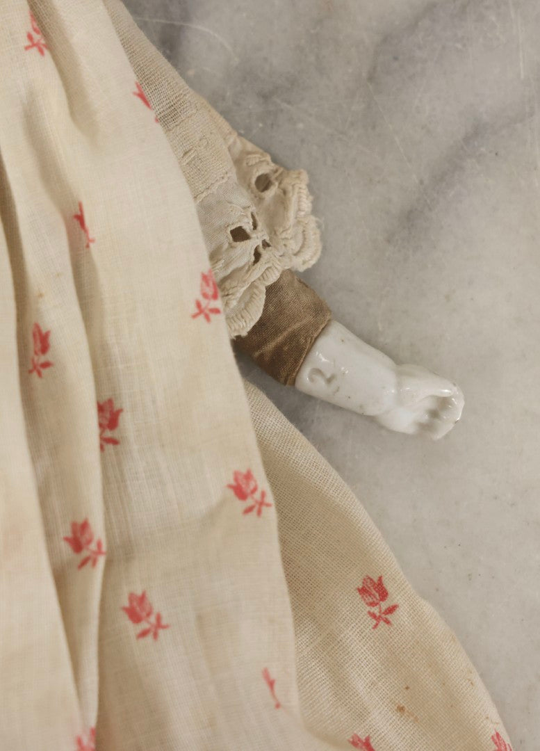 Lot 093 - Antique Doll With Porcelain Head, Hands And Feet And Cloth Body, With White Nightgown With Red Flower Print And Lace Borders, 12-1/4" H