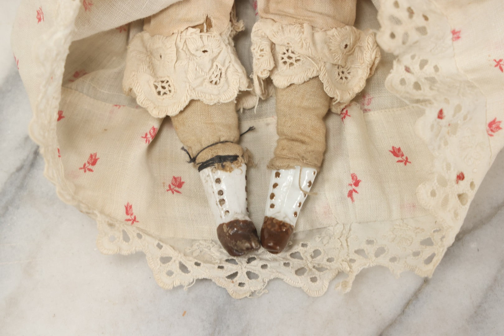 Lot 093 - Antique Doll With Porcelain Head, Hands And Feet And Cloth Body, With White Nightgown With Red Flower Print And Lace Borders, 12-1/4" H