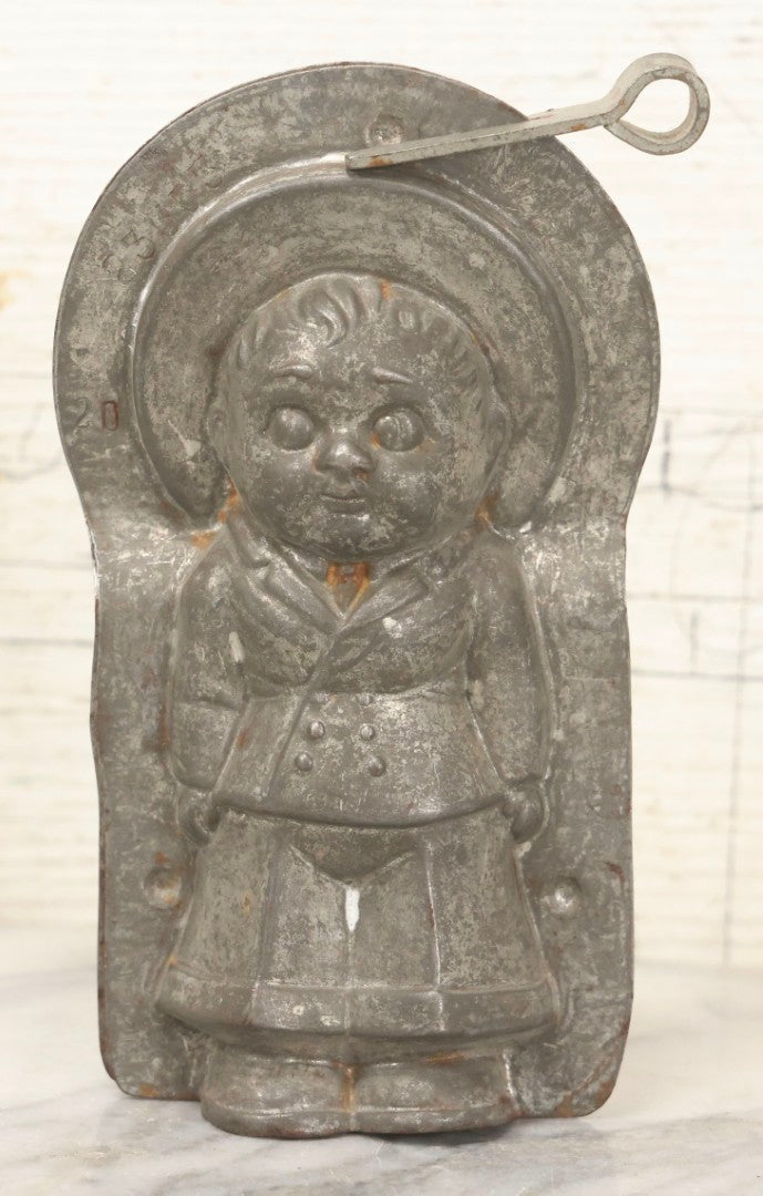 Lot 094 - Antique Anton Reich Dresden Tin Chocolate Mold Of Little Boy In Jacket, Square Pants, And Large Sun Hat, Missing Two Of Three Clips