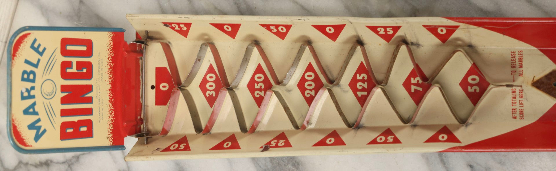 Lot 097 - Vintage Tin Lithograph "Marble Bingo" Toy With Folding Backboard And Spring Launcher, Made By Wolverine Supply Manufacturing Co., Pittsburgh, Pennsylvania, 16-1/2" L