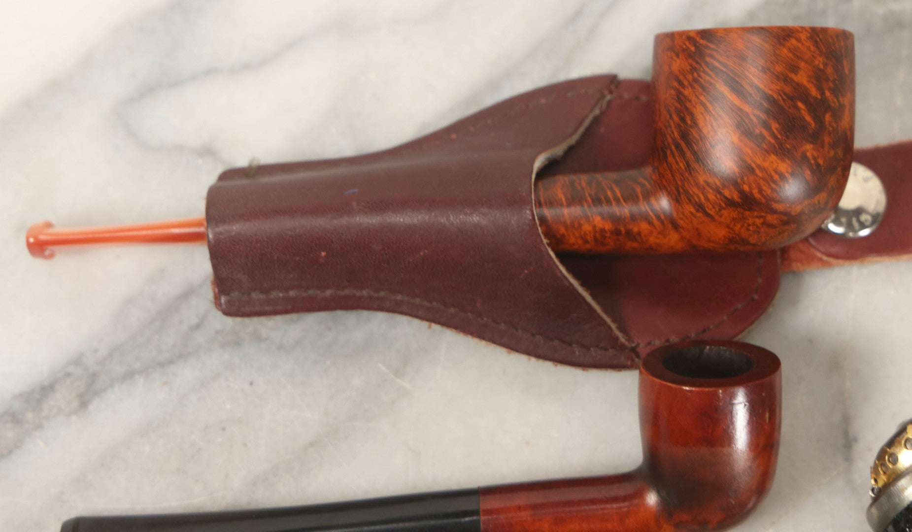 Lot 099 - Grouping Of Three Vintage Pipes Including Genuine Briar, Wood Grain With Sheath, And Painted Wood With Brass Cover