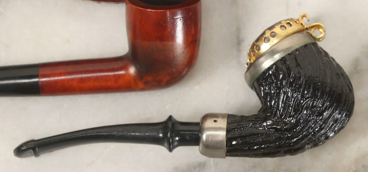 Lot 099 - Grouping Of Three Vintage Pipes Including Genuine Briar, Wood Grain With Sheath, And Painted Wood With Brass Cover