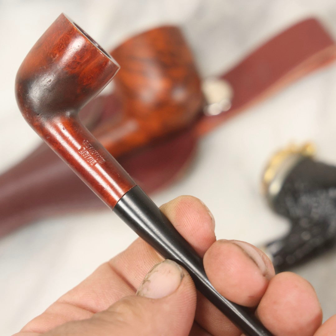 Lot 099 - Grouping Of Three Vintage Pipes Including Genuine Briar, Wood Grain With Sheath, And Painted Wood With Brass Cover