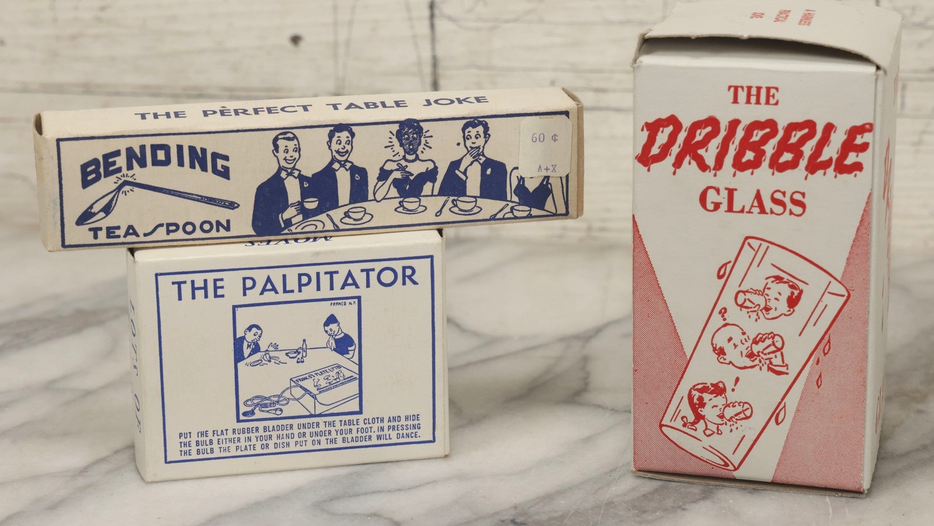 Lot 100 - Grouping Of Three Vintage Novelty Prank Tricks In Original Boxes Including Bending Teaspoon, "The Palpitator," And "The Dribble Glass"