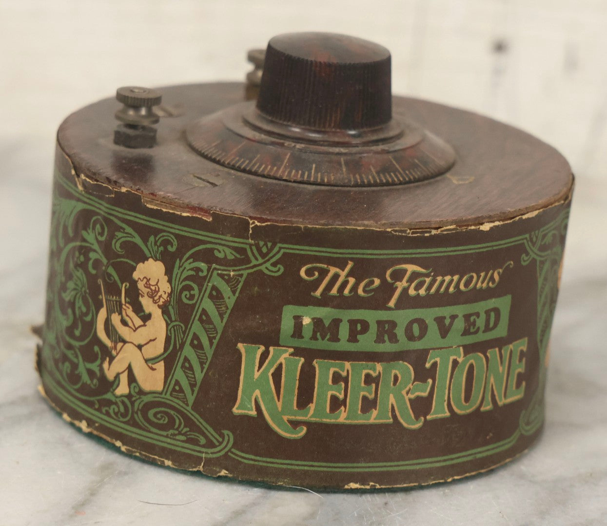 Lot 103 - Antique "The Famous Improved Kleer-Tone" Radio Tuner Variable Capacitor With Bakelite Knob And Cherub Motif Paper Wrap, 1920s