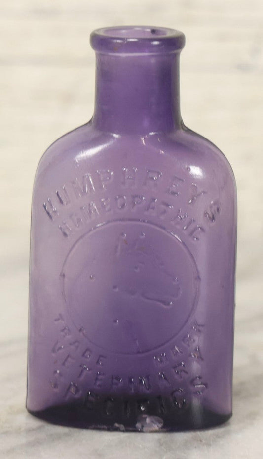 Lot 113 - Antique Embossed Purple Glass Bottle “Humphrey's Homeopathic Veterinary Specifics” With Horse Head Trademark, 3-1/2" H