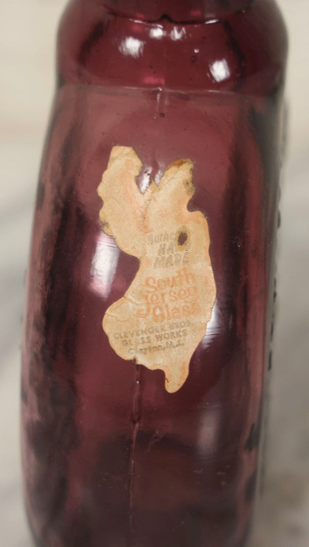 Lot 114 - Vintage Odd Fellows And Rebekah Commemorative Purple Glass Bottle, “New Jersey Eye Bank Visual Research Foundation,” 1973, With All-Seeing-Eye And F.L.T. Three Links, Clevenger Bros. Glass Works, Clayton, New Jersey, 7" H