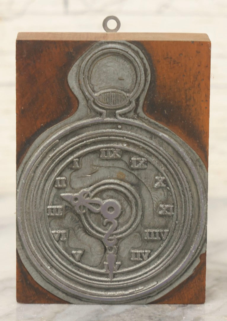 Lot 116 - Antique Printing Block Depicting Pocket Watch With Roman Numerals, With Added Wall Hanger Loop