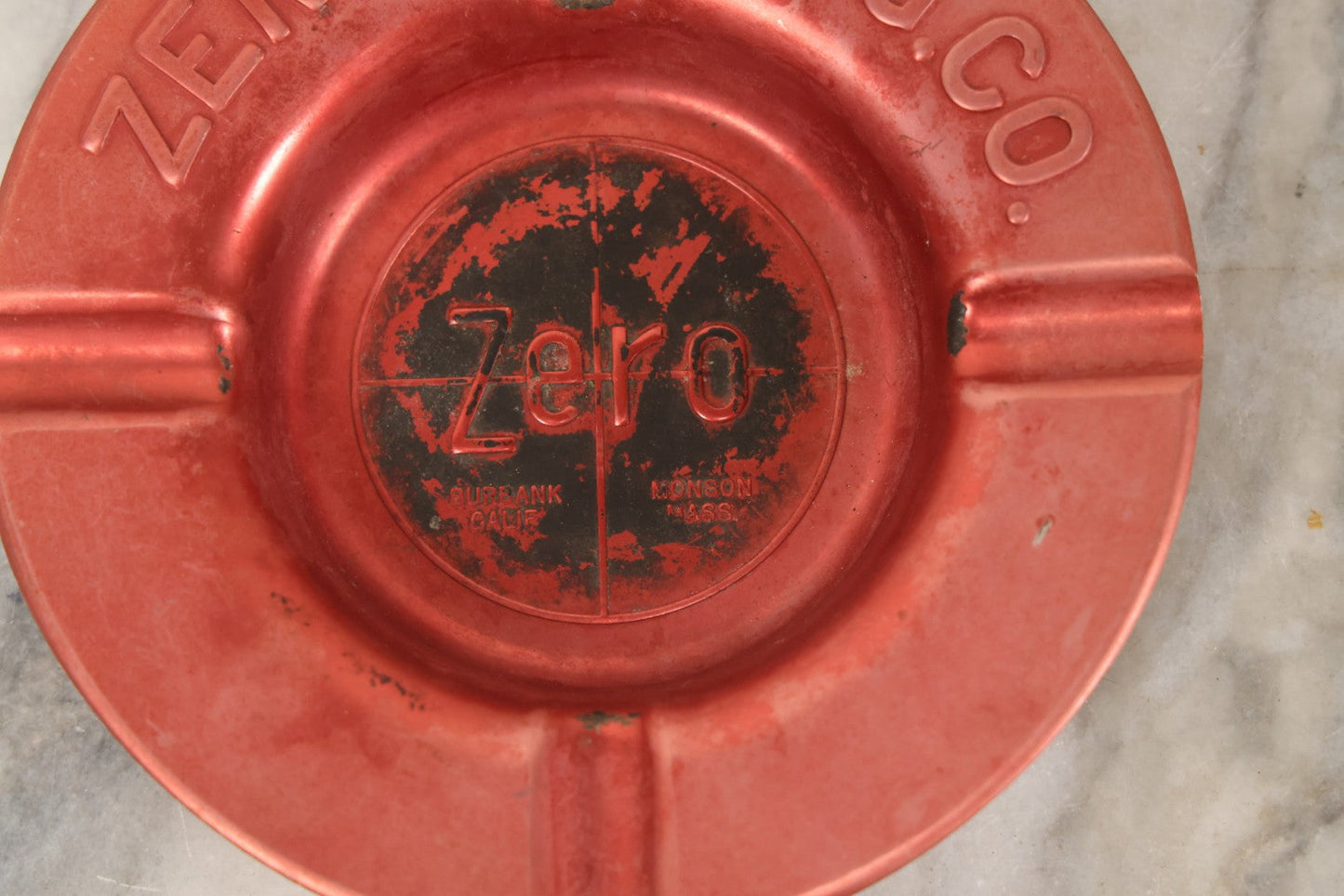 Lot 117 - Vintage Zero Mfg. Co. Pressed Metal Red Ashtray, Burbank, California / Monson, Massachusetts, 5-7/8" Diameter