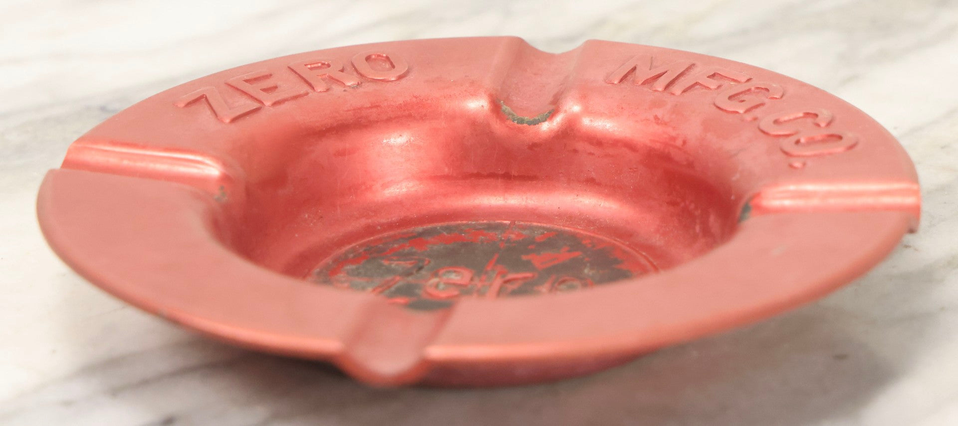 Lot 117 - Vintage Zero Mfg. Co. Pressed Metal Red Ashtray, Burbank, California / Monson, Massachusetts, 5-7/8" Diameter