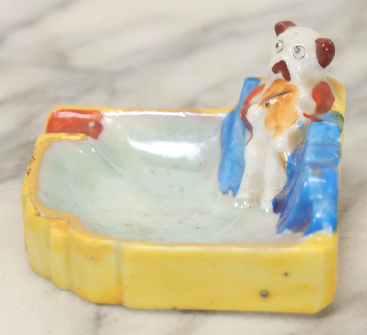 Lot 118 - Vintage Porcelain Novelty Ashtray With Dog Playing Violin On Blue Sofa, Made In Japan, 2-3/4" Wide