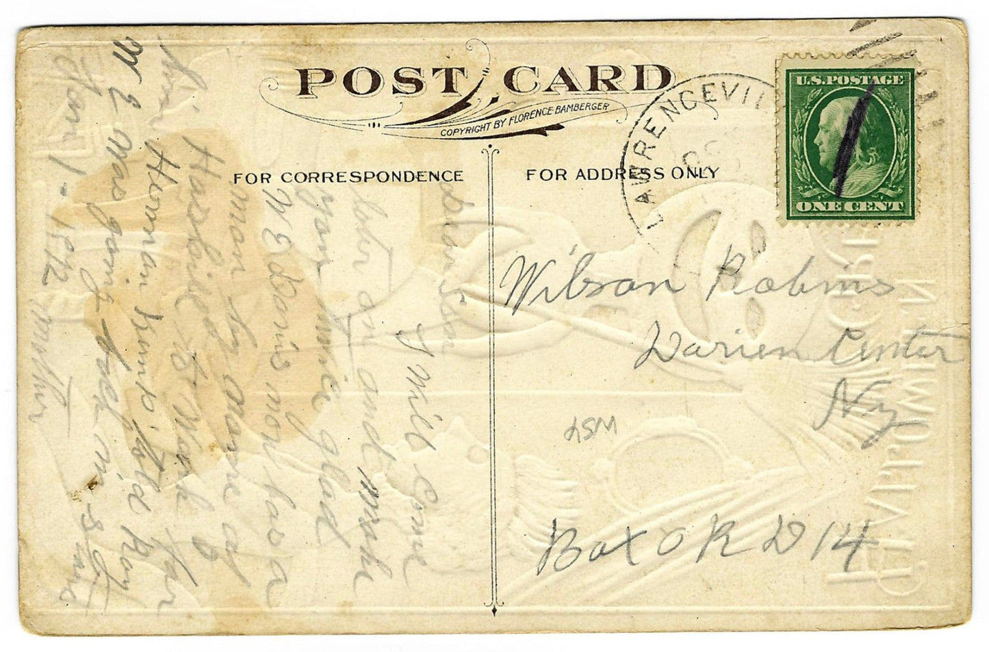 Lot 136 - Antique Embossed Hallowe'en Postcard “Hallowe'en Greetings” Depicting Woman At Table Surprised By Ghost With Jack-O-Lantern Head And Broom, Copyright Florence Bamberger, Postmarked Lawrenceville, Illinois, Written On Verso