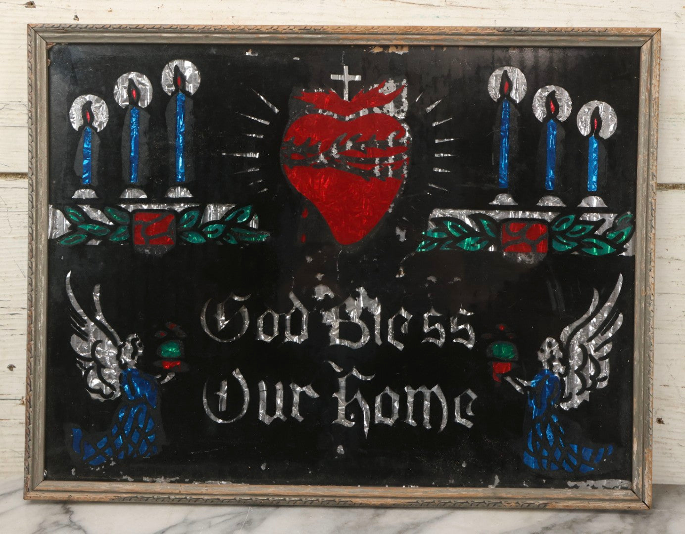 Lot 139 - Vintage Reverse Glass Tinsel Painting "God Bless Our Home" With Sacred Heart, Angels, And Candles, 16-3/4" x 12-3/4"