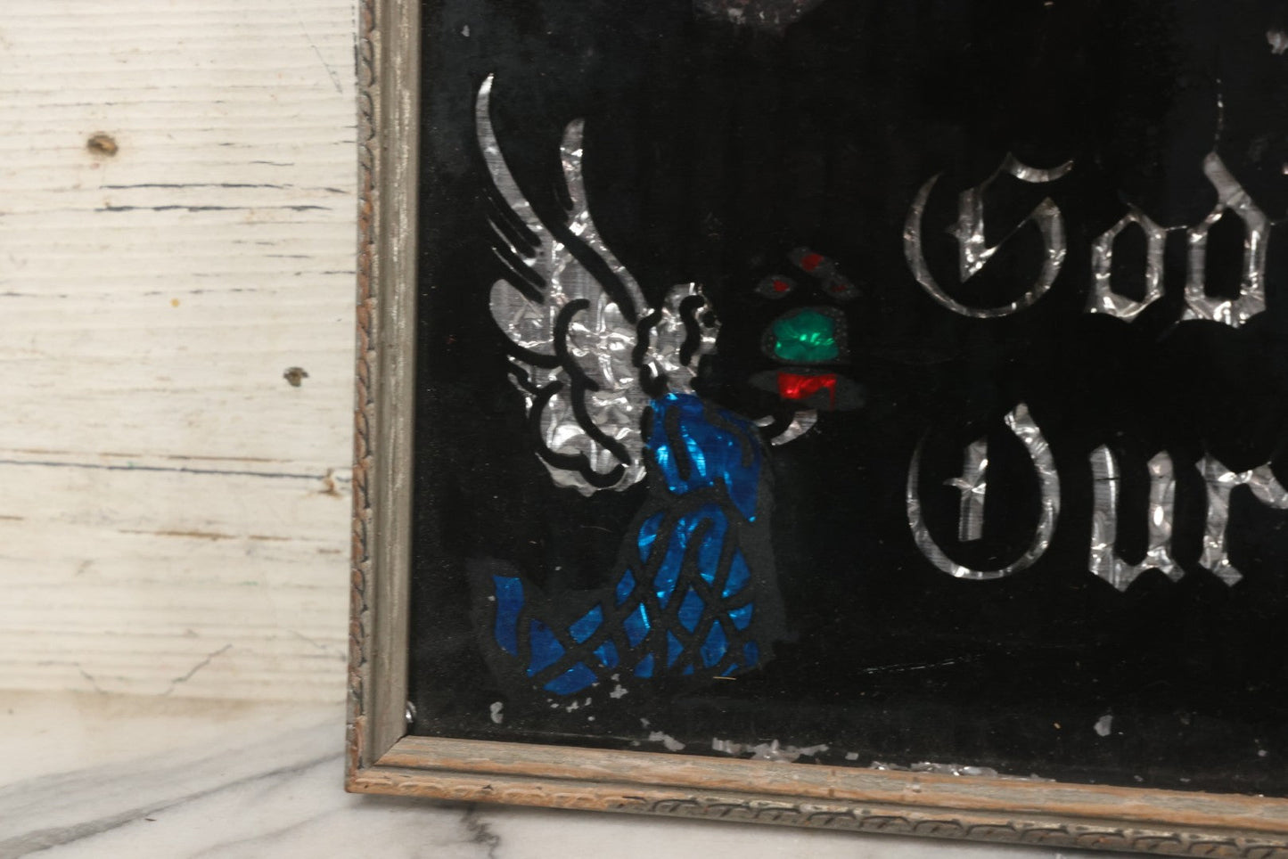 Lot 139 - Vintage Reverse Glass Tinsel Painting "God Bless Our Home" With Sacred Heart, Angels, And Candles, 16-3/4" x 12-3/4"