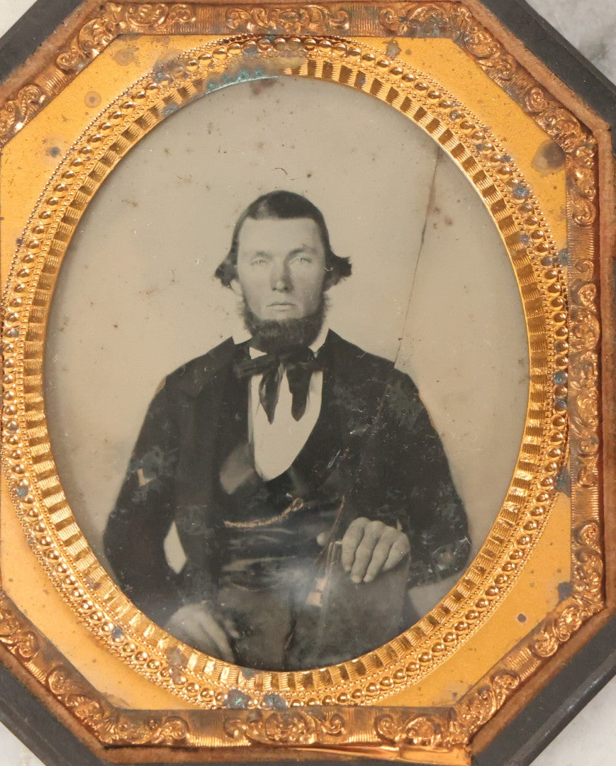 Lot 163 - Pair Of Antique 1/6th Plate Ambrotype Photographs Of Man And Woman Holding Books In Double Sided Thermoplastic Union Case, Note Damage