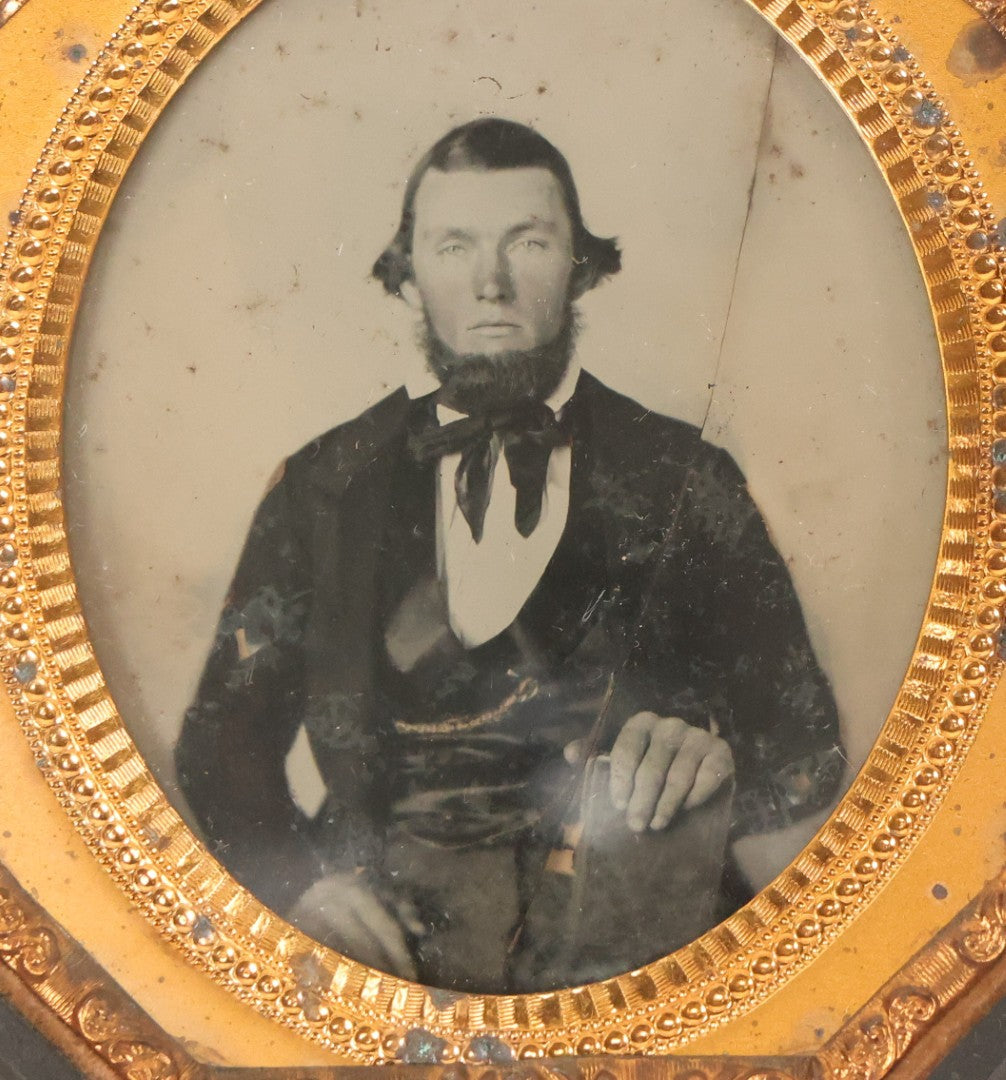 Lot 163 - Pair Of Antique 1/6th Plate Ambrotype Photographs Of Man And Woman Holding Books In Double Sided Thermoplastic Union Case, Note Damage