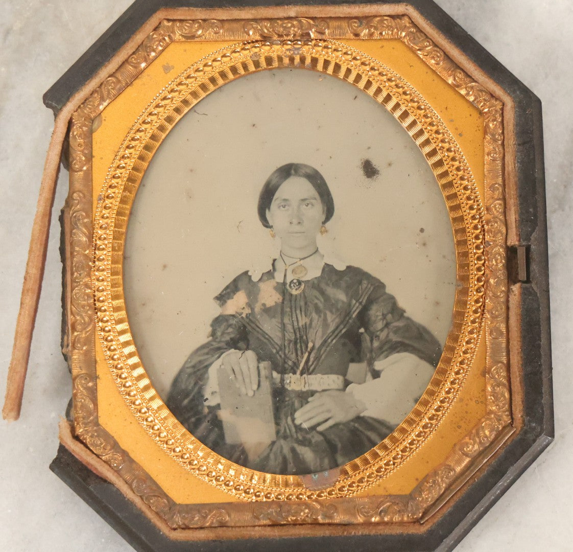 Lot 163 - Pair Of Antique 1/6th Plate Ambrotype Photographs Of Man And Woman Holding Books In Double Sided Thermoplastic Union Case, Note Damage