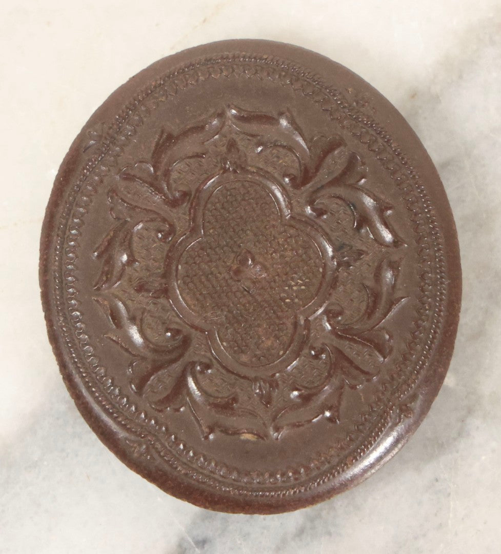 Lot 164 - Antique Oval-Cut Tintype Photograph Of Woman In Bonnet With Flowers And Bow Scarf, In Brown Thermoplastic “Oreo”-Style Case With Brass Preserver, 1-7/8" x 2-1/8"
