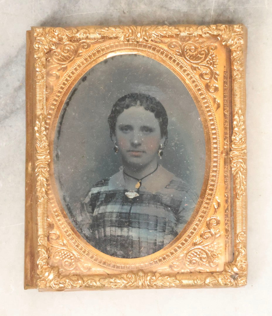 Lot 165 - Grouping Of Three Antique Portrait Photographs, One Tintype Of A Young Man, Two Ruby Ambrotypes In Brass Mats Including Young Woman With Hand-Painted Jewelry And Young Man In Bowtie