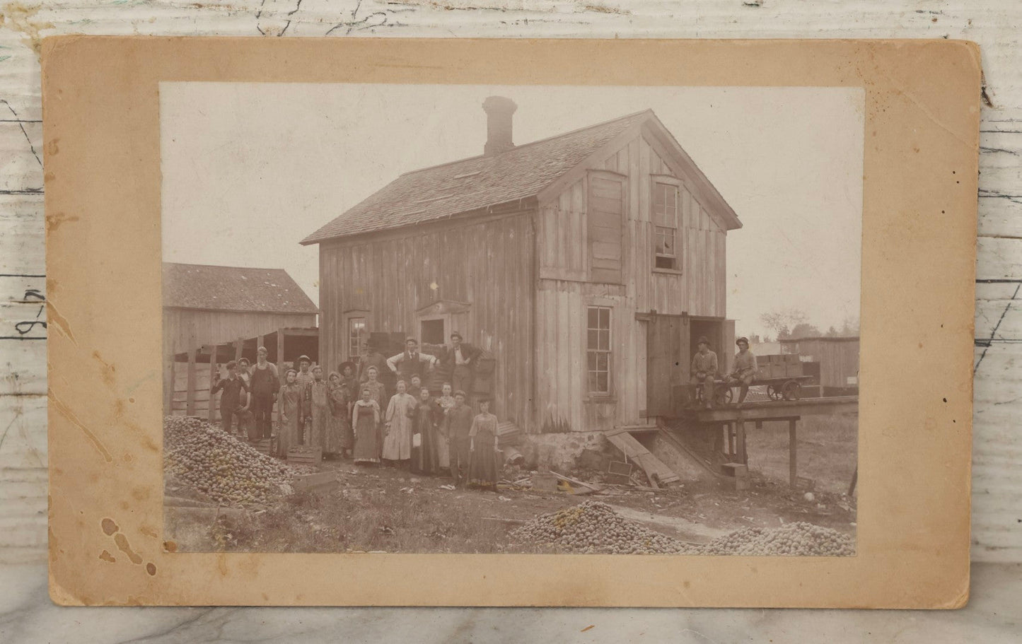 Lot 167 - Antique Boarded Occupational Photograph Of Farm Workers With Apple Harvest, Bad River Reservation, Northern Wisconsin