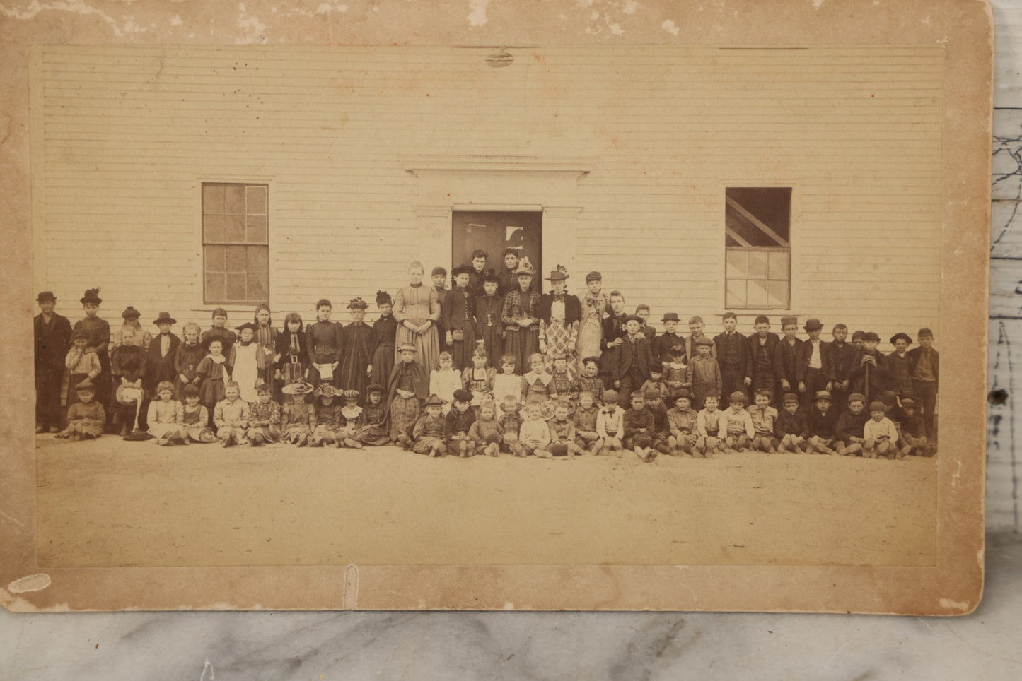 Lot 168 - Antique Boarded Photograph Of Large School Class With Teachers Before Schoolhouse, Numbered And Annotated On Verso