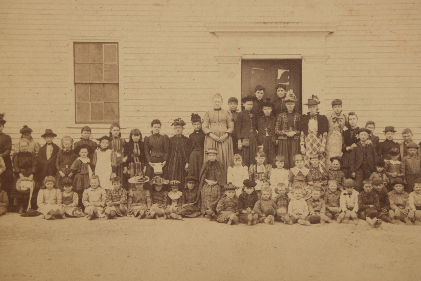 Lot 168 - Antique Boarded Photograph Of Large School Class With Teachers Before Schoolhouse, Numbered And Annotated On Verso