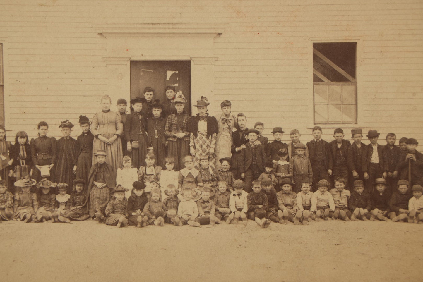 Lot 168 - Antique Boarded Photograph Of Large School Class With Teachers Before Schoolhouse, Numbered And Annotated On Verso