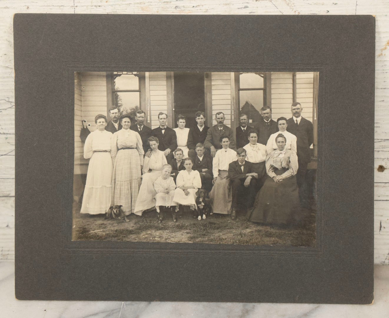 Lot 171 - Antique Boarded Group Family Photograph Of Three Generations Posed On Steps Of House With Two Dogs