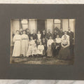 Lot 171 - Antique Boarded Group Family Photograph Of Three Generations Posed On Steps Of House With Two Dogs