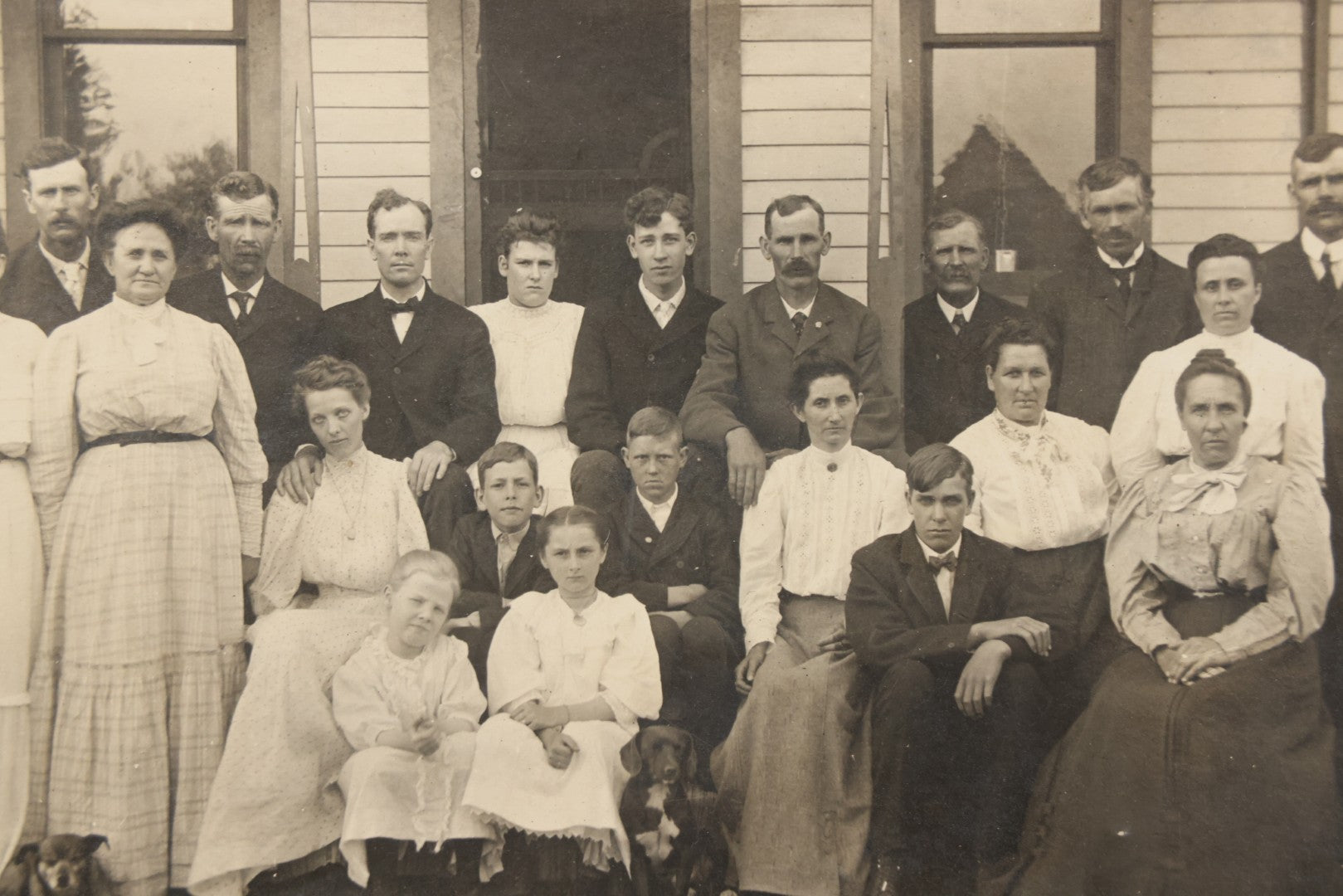 Lot 171 - Antique Boarded Group Family Photograph Of Three Generations Posed On Steps Of House With Two Dogs