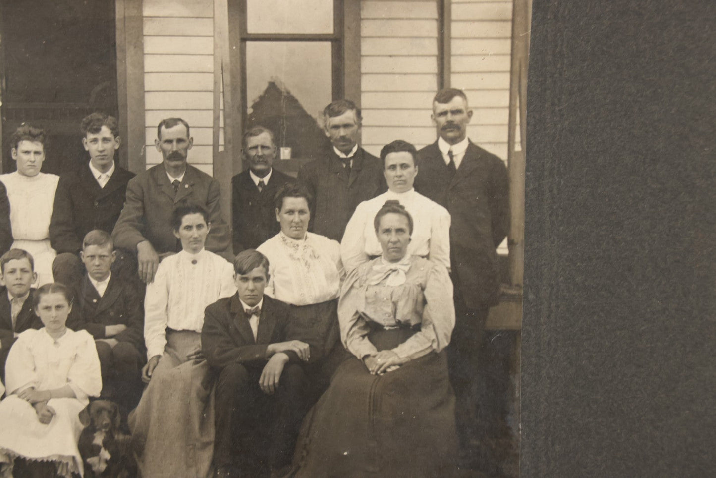 Lot 171 - Antique Boarded Group Family Photograph Of Three Generations Posed On Steps Of House With Two Dogs