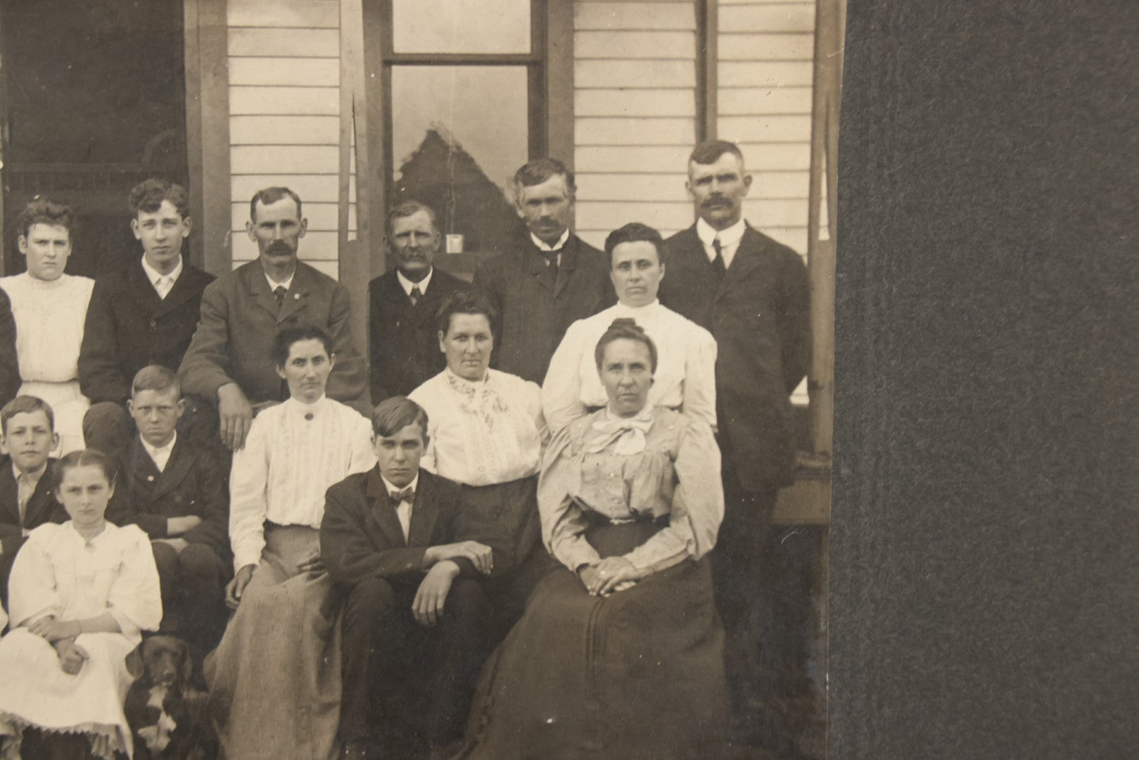Lot 171 - Antique Boarded Group Family Photograph Of Three Generations Posed On Steps Of House With Two Dogs