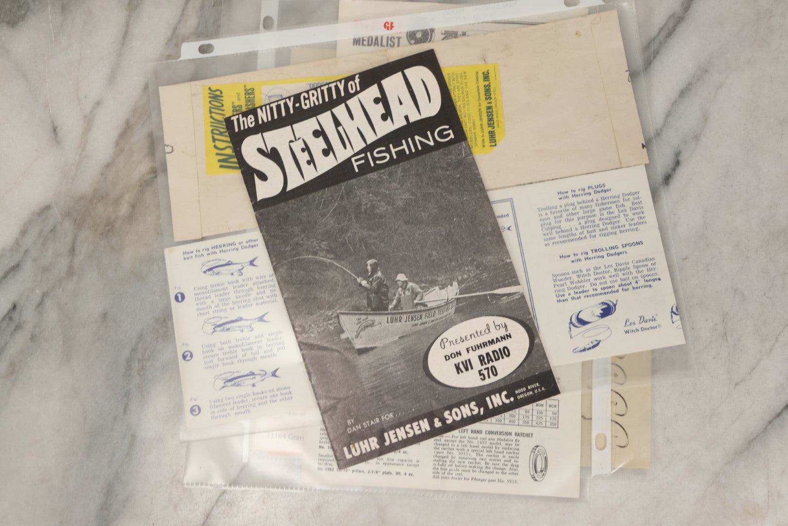Lot 212 - Grouping Of Vintage Fishing Ephemera Including Pflueger Reel Advertisements And Booklets, "The Nitty Gritty Of Steelhead Fishing" By Dan Stair For Luhr Jensen & Sons, And Shoff Sporting Goods Chart, Kent, Washington