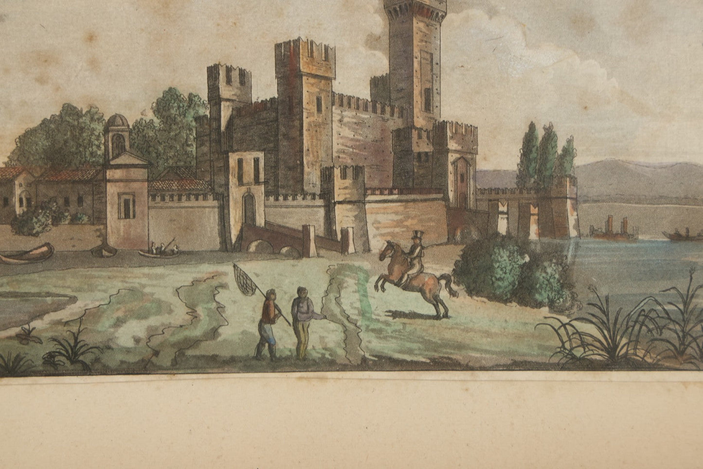 Lot 223 - Antique Hand-Colored Engraving Scaligera Castle, Sirmione, Lake Garda, Italy, Circa Early 19th Century, Mounted Behind Glass With Backing Board And Sealing Tape Border