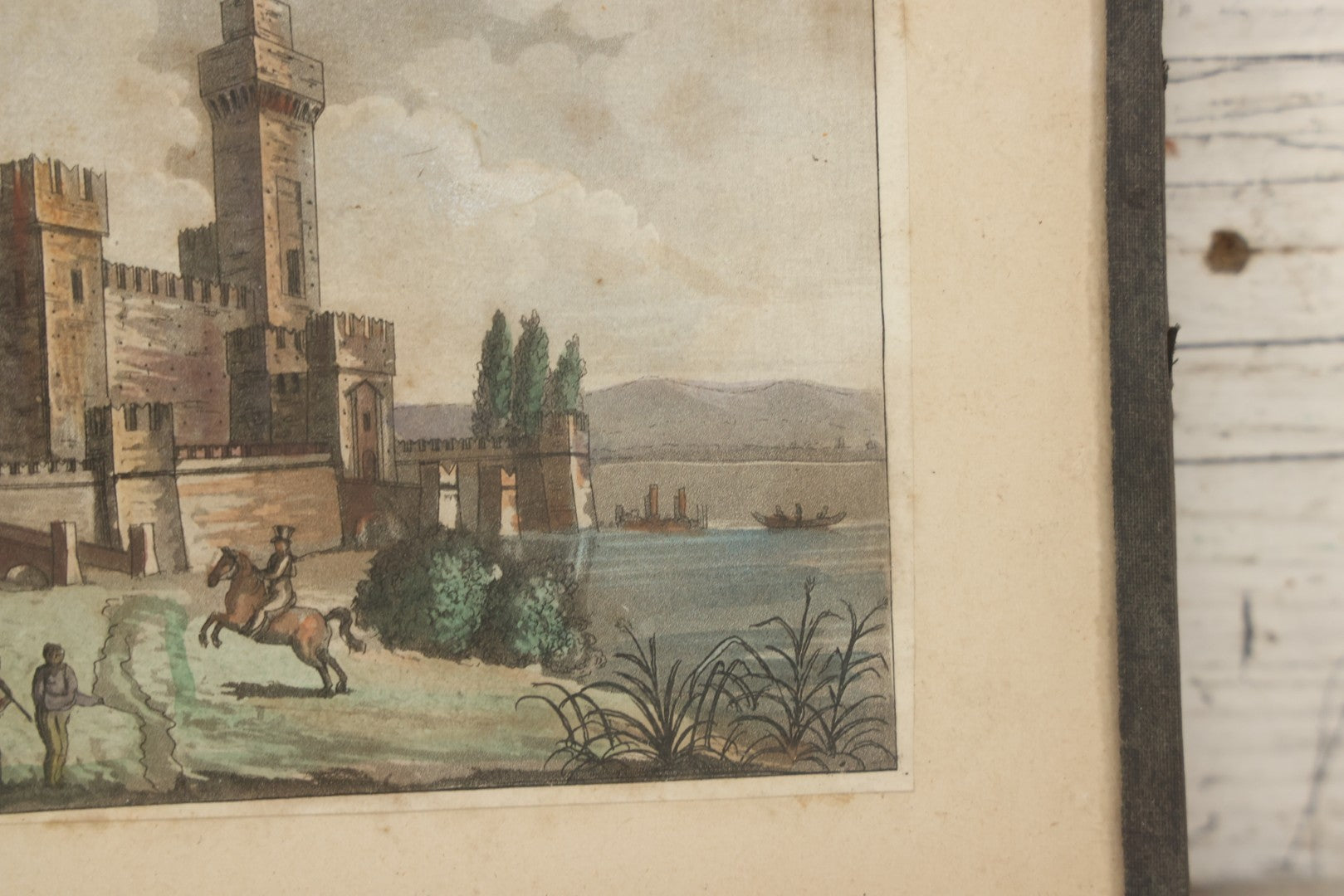 Lot 223 - Antique Hand-Colored Engraving Scaligera Castle, Sirmione, Lake Garda, Italy, Circa Early 19th Century, Mounted Behind Glass With Backing Board And Sealing Tape Border