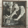 Lot 233 - Vintage Industrial Safety Photograph “Caught!—Floppy Clothing Has No Place Around Moving Machinery,” Signed Sarra, In Gray Painted Frame, 11-1/8" x 12-1/8"