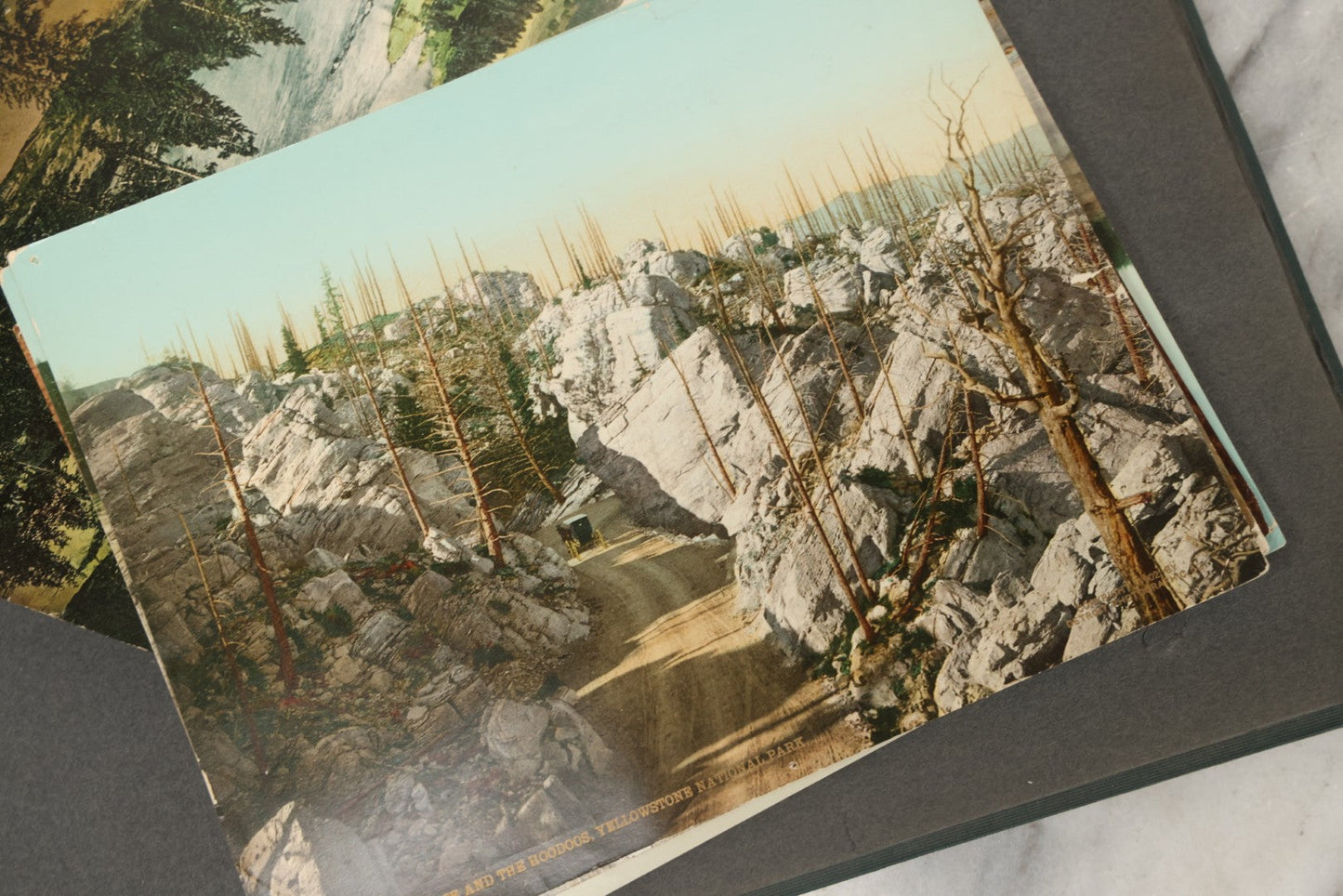 Lot 238 - Antique “Postal Cards” Scrapbook Album Containing Yellowstone Photographs, Postcards, And Ephemera Including Large-Format 1898–1902 Prints By Detroit Photographic Co., Ward's Postal Card Album, Boston, Massachusetts