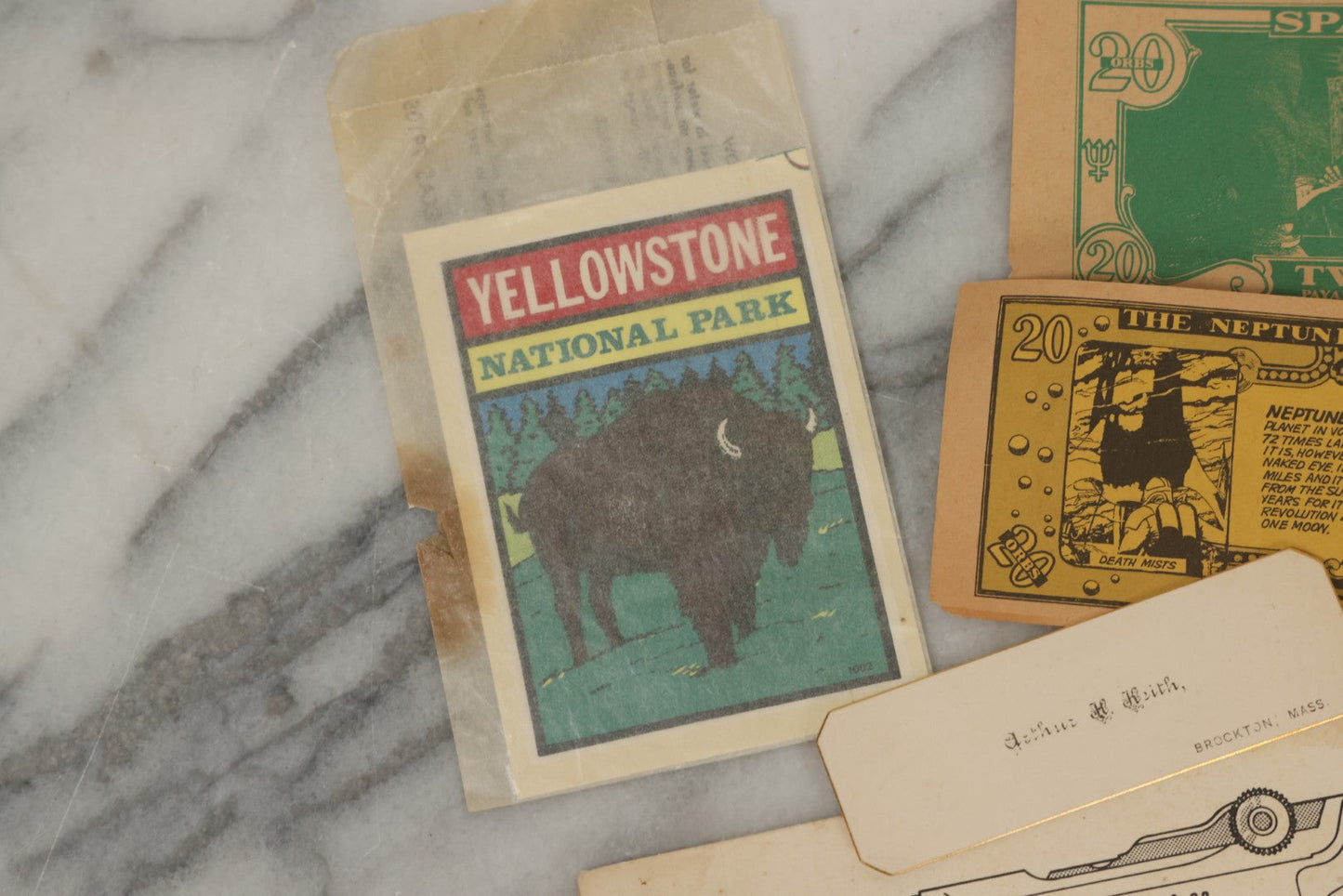 Lot 242 - Grouping Of 15 Antique And Vintage Mixed Ephemera Scraps Including Novelty Space Money From Neptune, 1882 Award Of Merit, Hand Motif Calling Cards, New England Jewelry Co. Coupon, Cat Booklet, Yellowstone Decal, And Erma EP22 Pistol Booklet