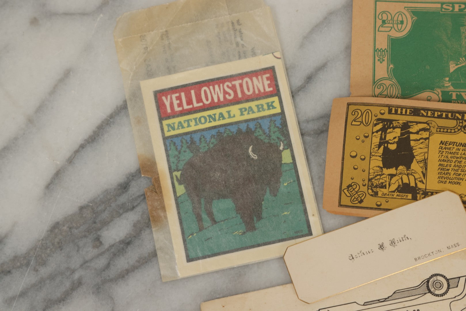 Lot 242 - Grouping Of 15 Antique And Vintage Mixed Ephemera Scraps Including Novelty Space Money From Neptune, 1882 Award Of Merit, Hand Motif Calling Cards, New England Jewelry Co. Coupon, Cat Booklet, Yellowstone Decal, And Erma EP22 Pistol Booklet