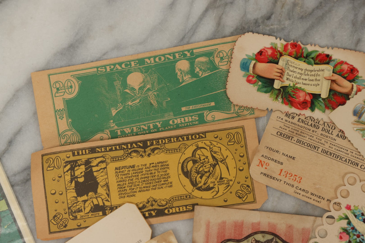 Lot 242 - Grouping Of 15 Antique And Vintage Mixed Ephemera Scraps Including Novelty Space Money From Neptune, 1882 Award Of Merit, Hand Motif Calling Cards, New England Jewelry Co. Coupon, Cat Booklet, Yellowstone Decal, And Erma EP22 Pistol Booklet