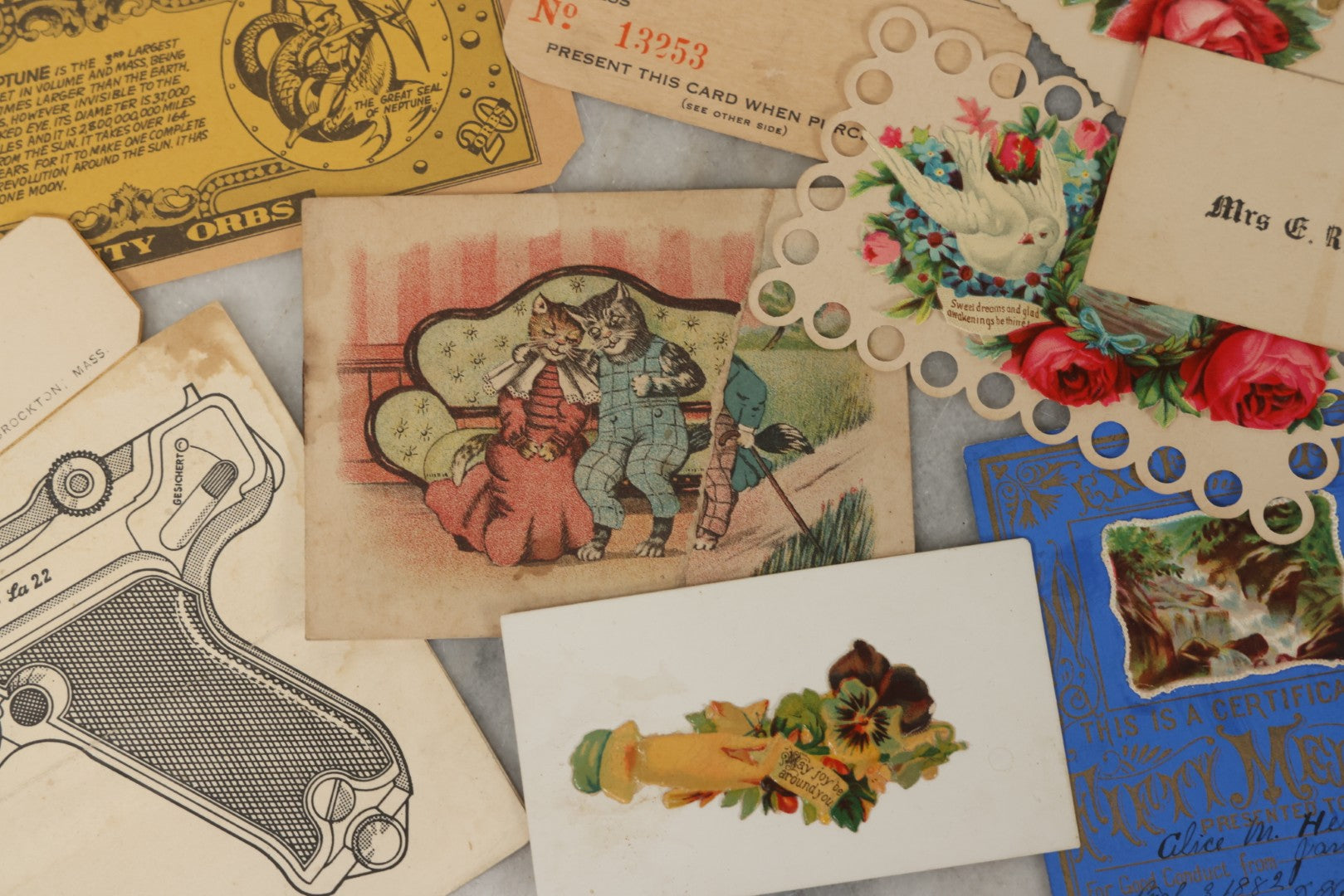 Lot 242 - Grouping Of 15 Antique And Vintage Mixed Ephemera Scraps Including Novelty Space Money From Neptune, 1882 Award Of Merit, Hand Motif Calling Cards, New England Jewelry Co. Coupon, Cat Booklet, Yellowstone Decal, And Erma EP22 Pistol Booklet