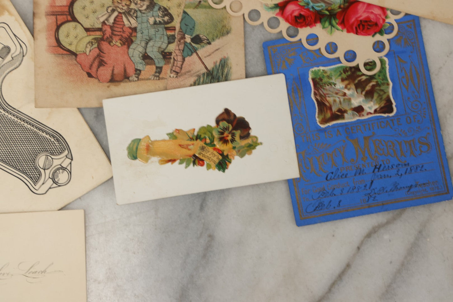Lot 242 - Grouping Of 15 Antique And Vintage Mixed Ephemera Scraps Including Novelty Space Money From Neptune, 1882 Award Of Merit, Hand Motif Calling Cards, New England Jewelry Co. Coupon, Cat Booklet, Yellowstone Decal, And Erma EP22 Pistol Booklet