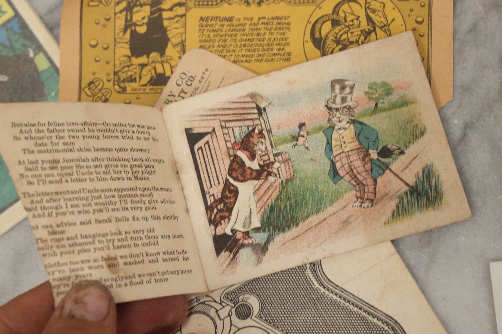 Lot 242 - Grouping Of 15 Antique And Vintage Mixed Ephemera Scraps Including Novelty Space Money From Neptune, 1882 Award Of Merit, Hand Motif Calling Cards, New England Jewelry Co. Coupon, Cat Booklet, Yellowstone Decal, And Erma EP22 Pistol Booklet