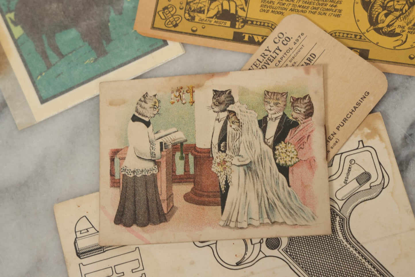 Lot 242 - Grouping Of 15 Antique And Vintage Mixed Ephemera Scraps Including Novelty Space Money From Neptune, 1882 Award Of Merit, Hand Motif Calling Cards, New England Jewelry Co. Coupon, Cat Booklet, Yellowstone Decal, And Erma EP22 Pistol Booklet