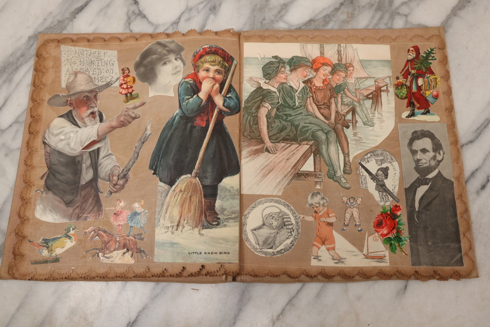 Lot 134 - Antique Linen Scrapbook With Fabric Pages Containing Over 100 Hand Cut Magazine Clippings Including Santa, Children, Animals, Kewpies, Women, Advertisements, And More Circa 1913