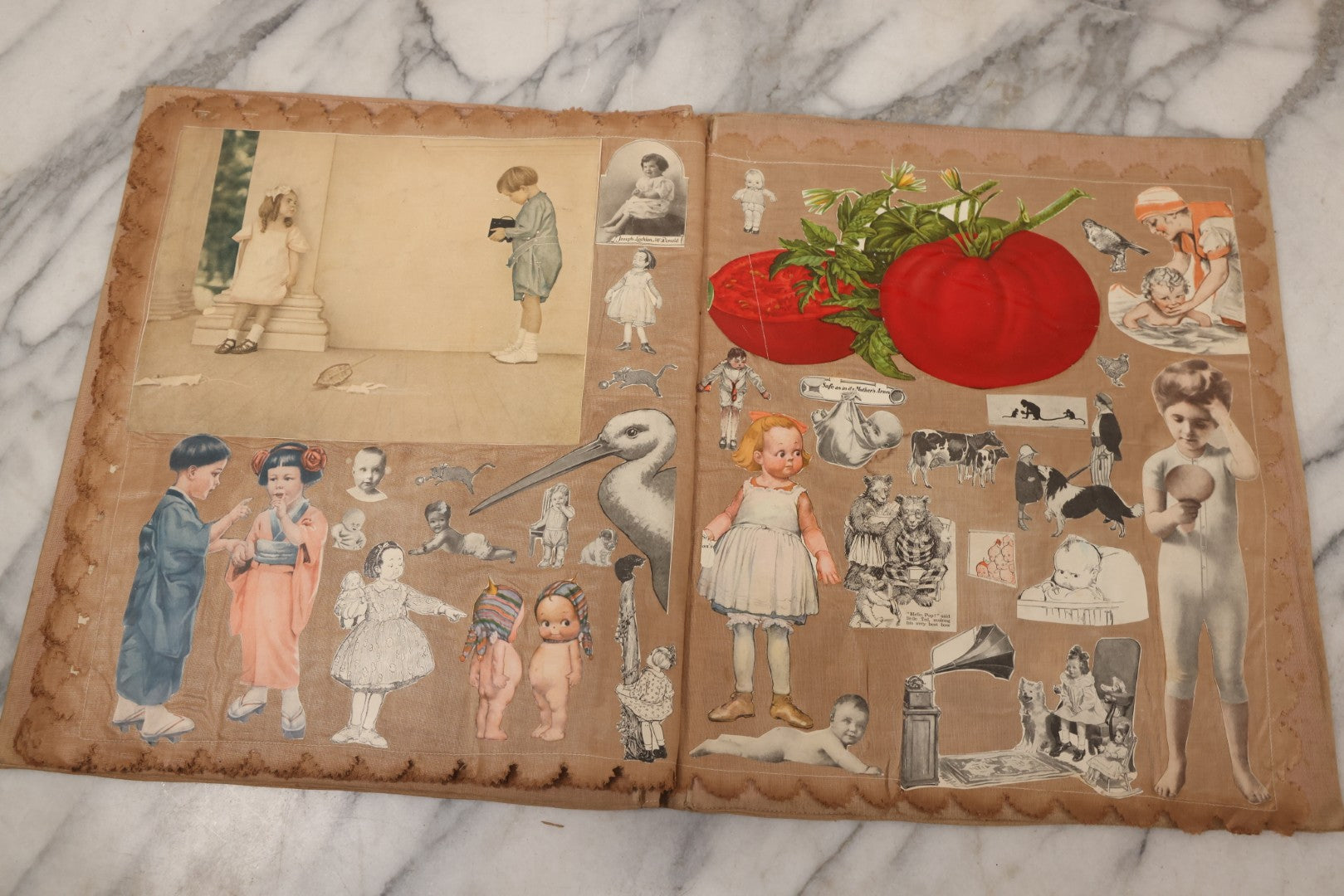 Lot 134 - Antique Linen Scrapbook With Fabric Pages Containing Over 100 Hand Cut Magazine Clippings Including Santa, Children, Animals, Kewpies, Women, Advertisements, And More Circa 1913